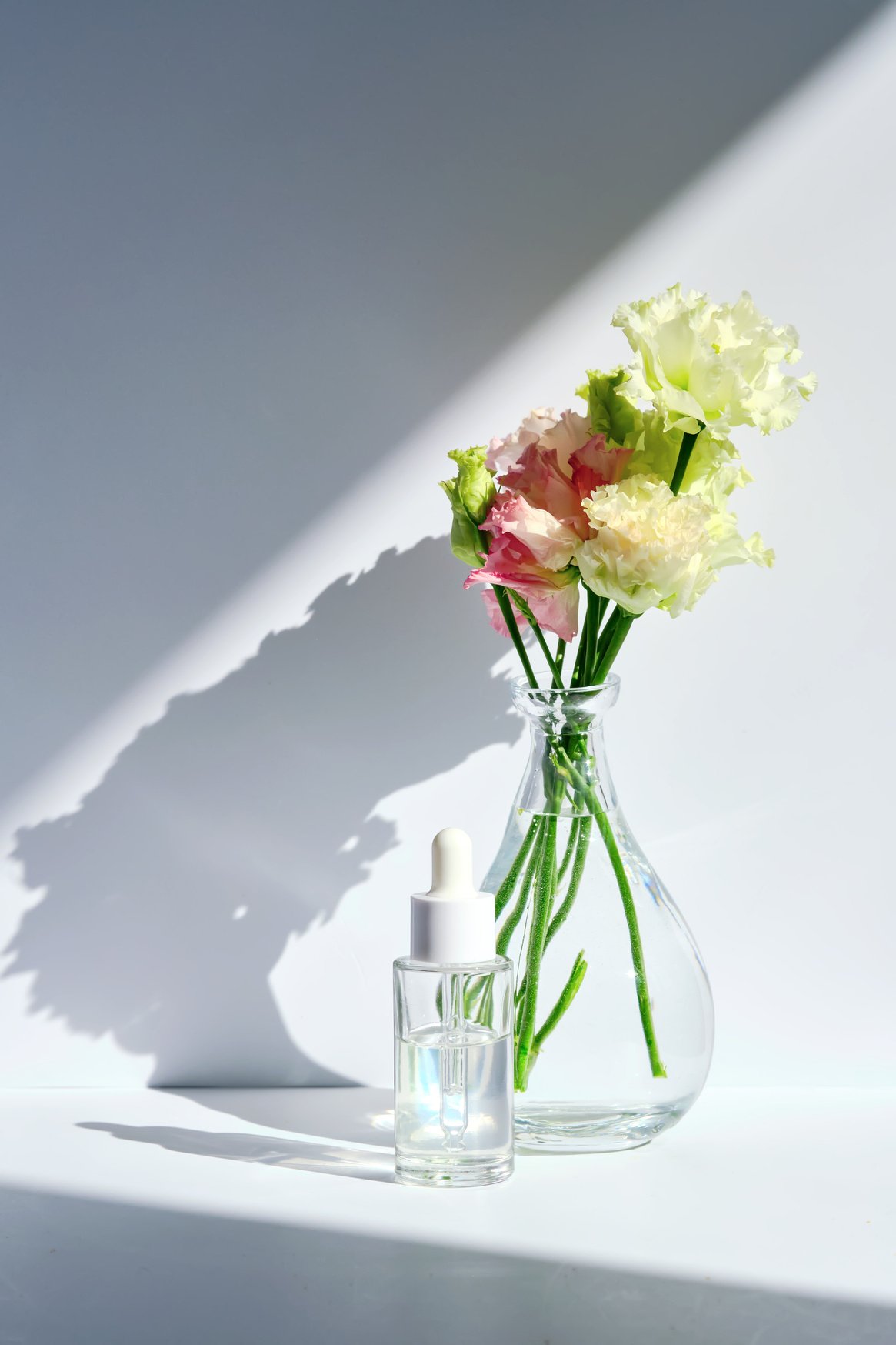 Serum with a dropper with spring flowers.