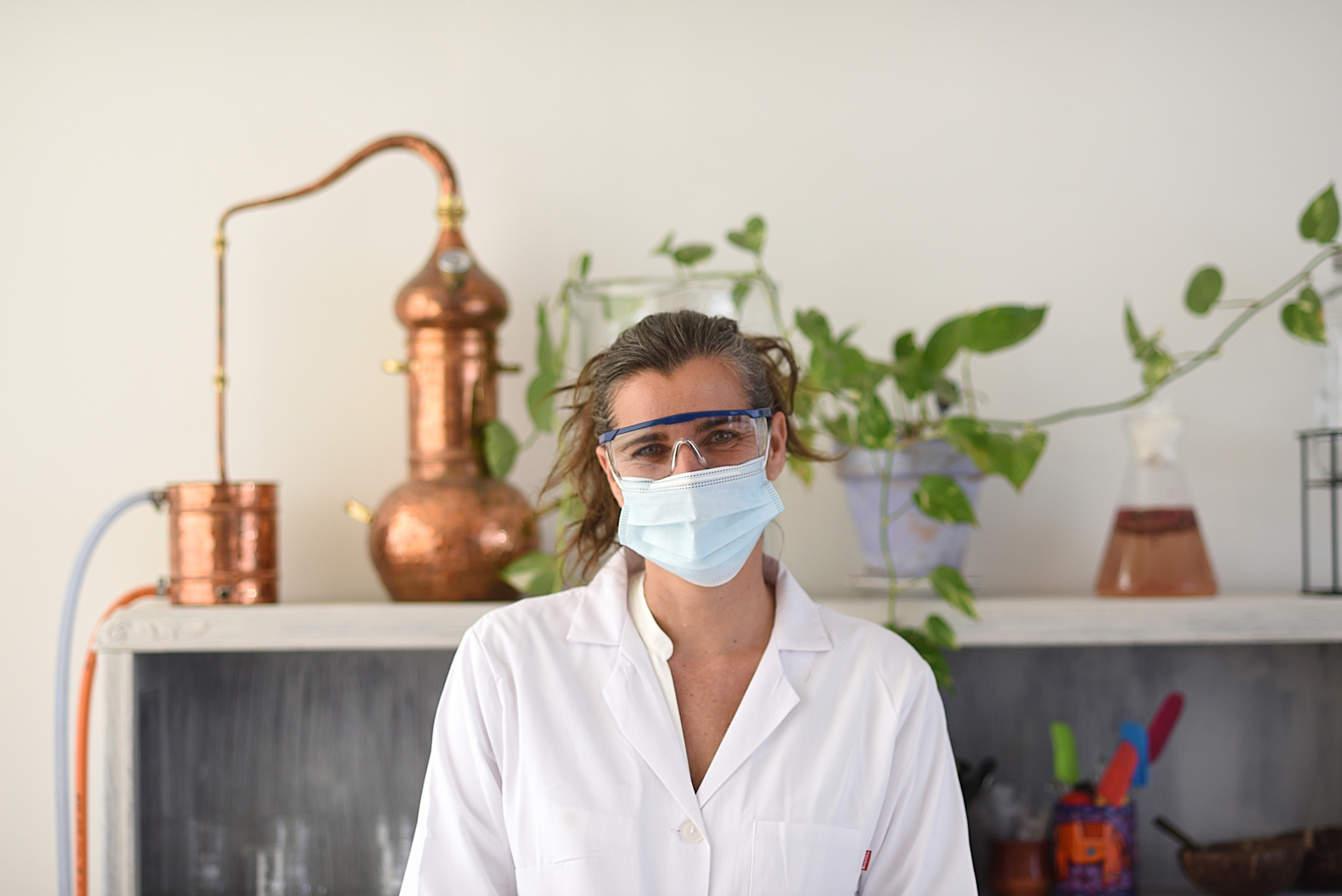 Female chemist smiles in her natural cosmetics lab